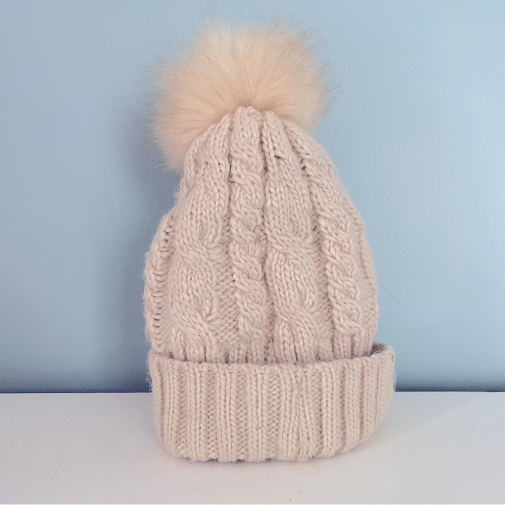 Cable knit cream colored hat with pom-pom